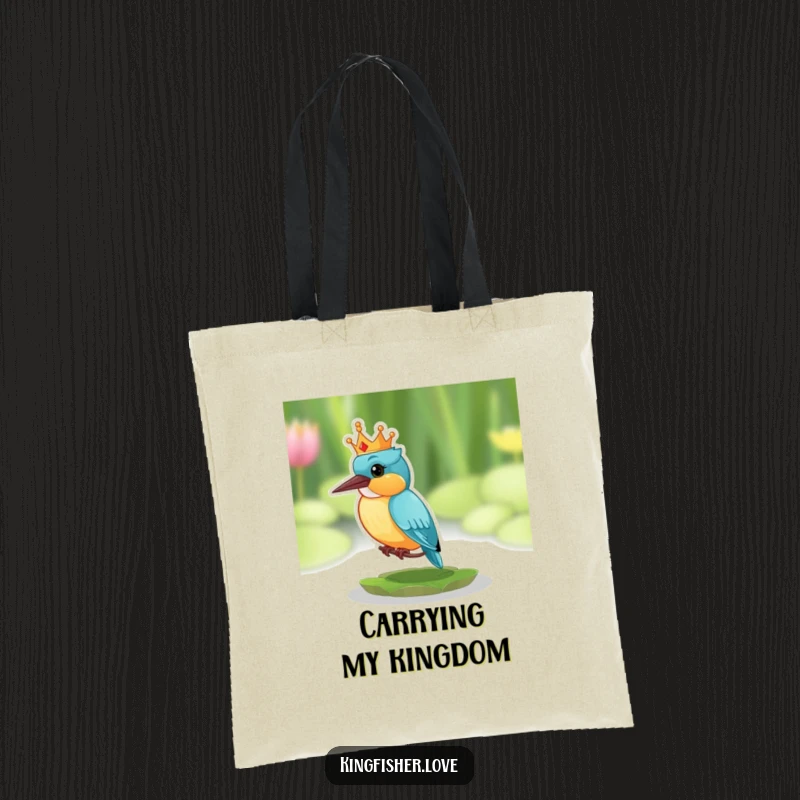 Funny tote bag with a kingfisher wearing a tiny crown, looking surprised while perched on a lily pad.