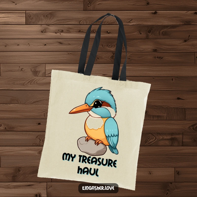 Funny tote bag with a kingfisher holding a shiny pebble in its beak, head tilted curiously, perfect for carrying items with humor.